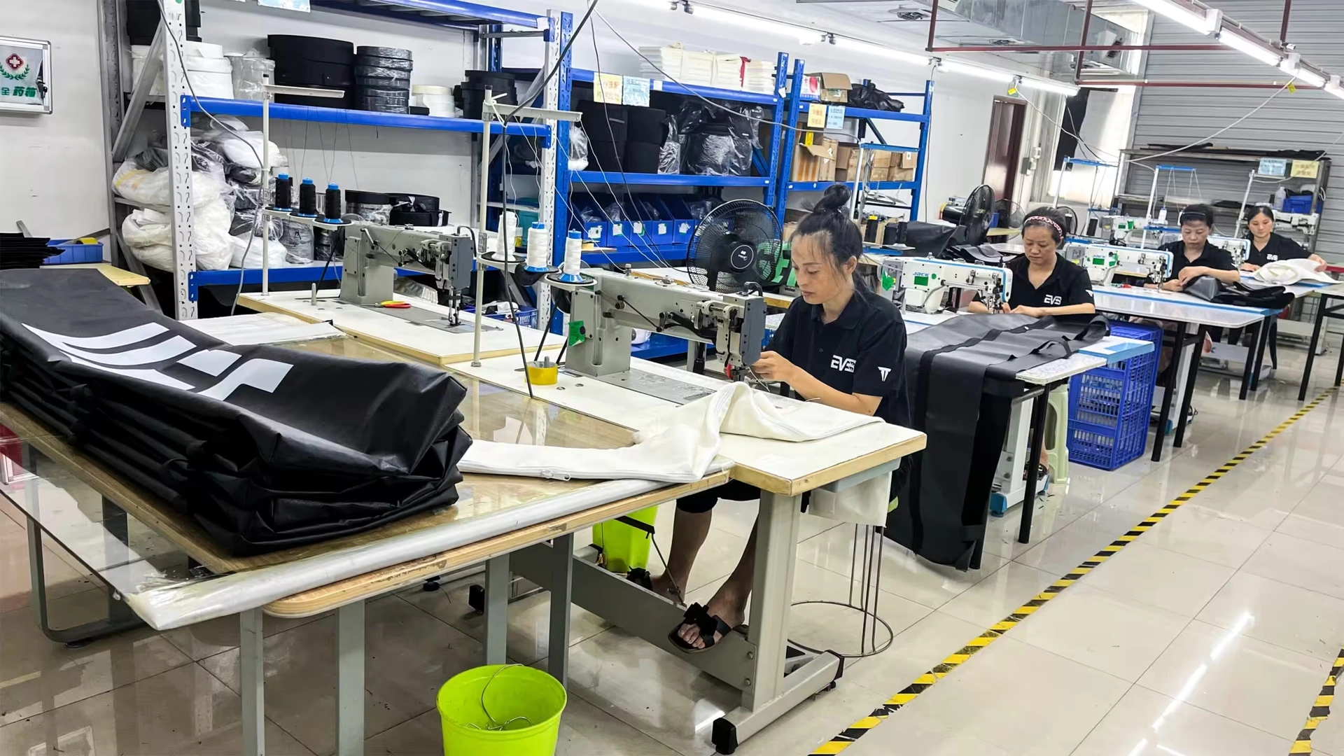 Home 10 Workers operating industrial sewing machines in a sewing workshop