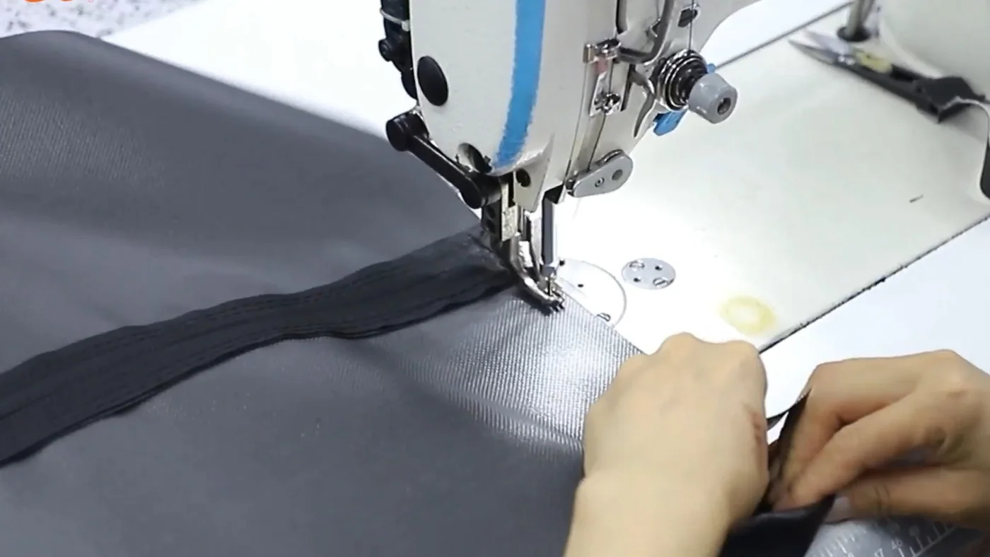 Fabric and binding under an industrial sewing machine