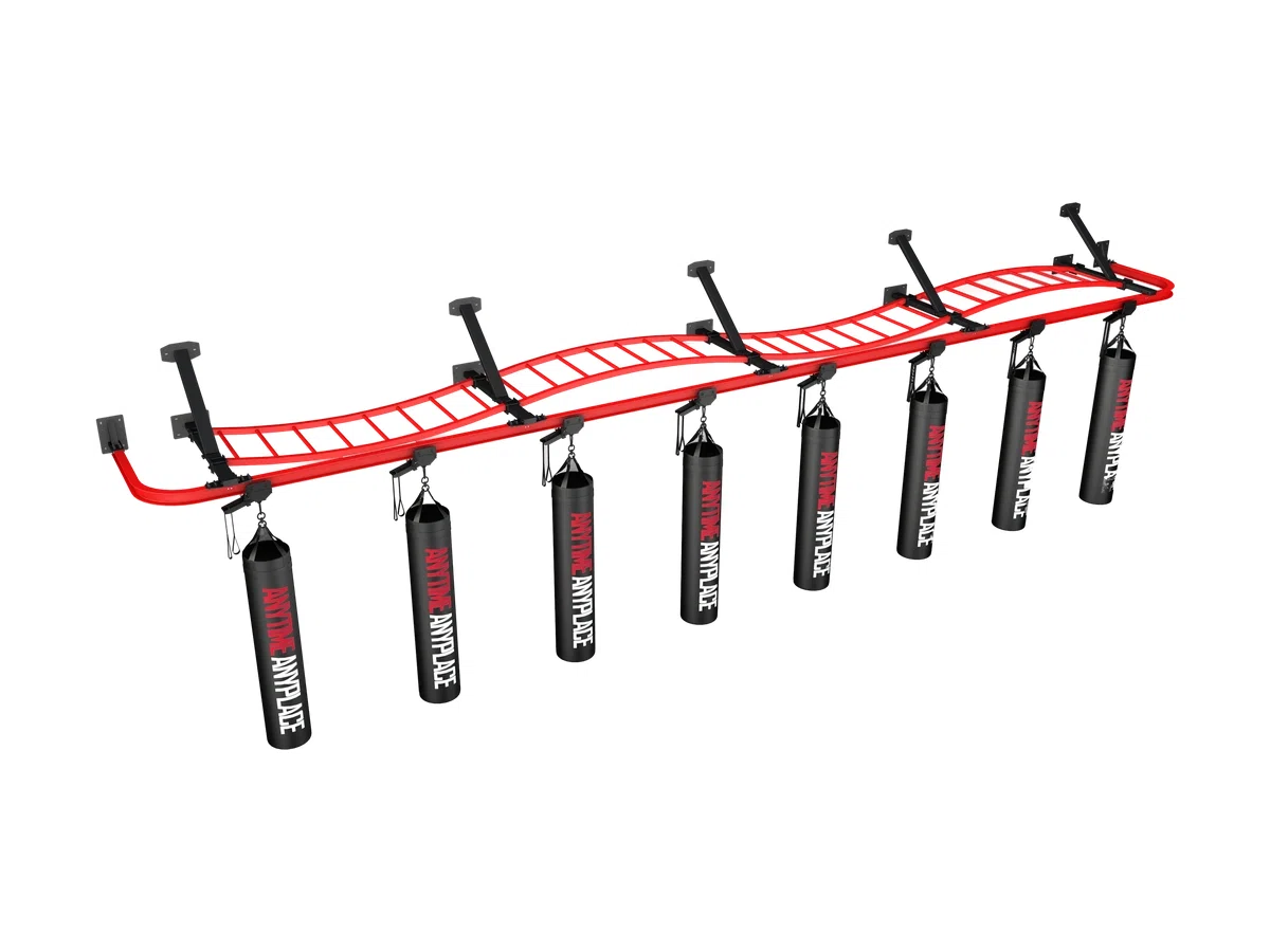 Commercial track-mounted heavy bag rail system with sliding trolleys for boxing gym space optimization
